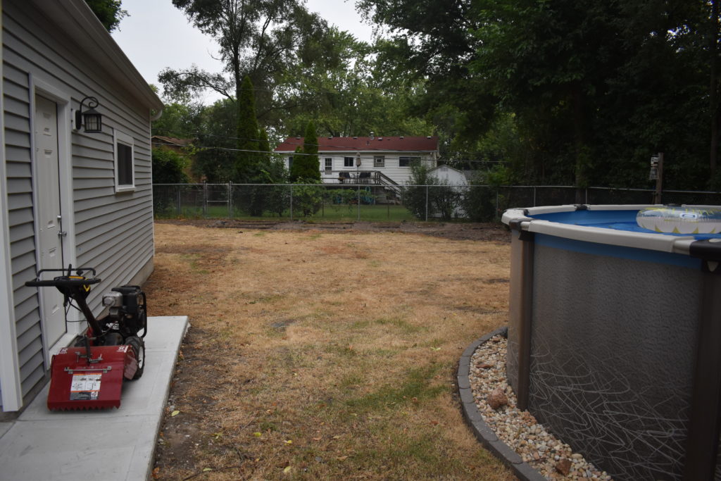 Dead, worn backyard lawn before removal and new sod